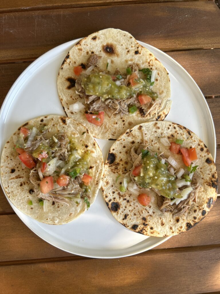pork tacos on a white plate