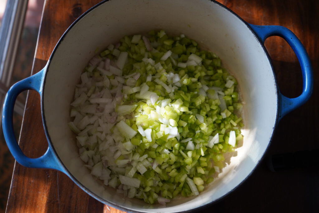 a Dutch oven with chopped vegetables inside