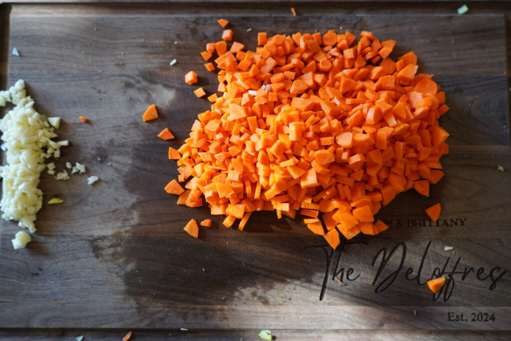 a cutting board with carrots finely chopped