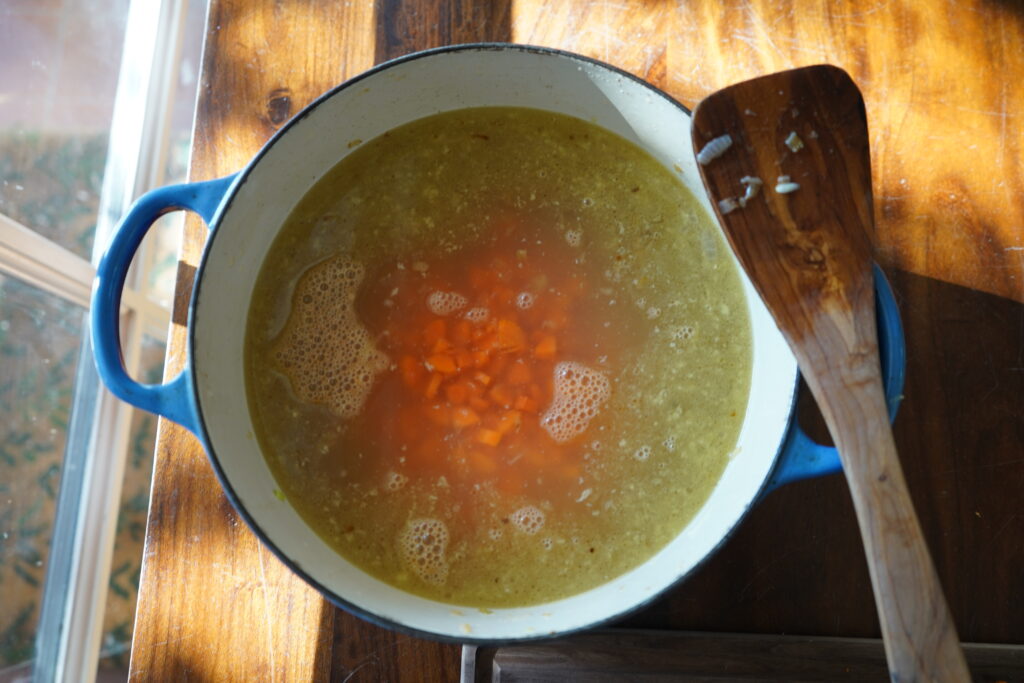 a Dutch oven filled with broth