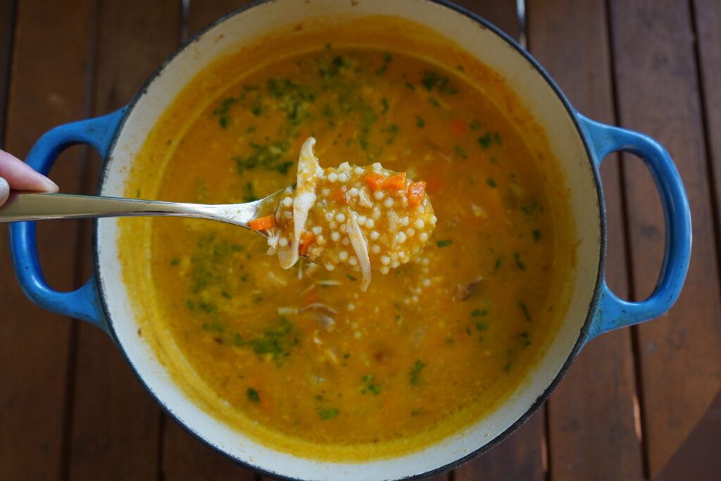 A spoon scooping penicillin soup out of a pot