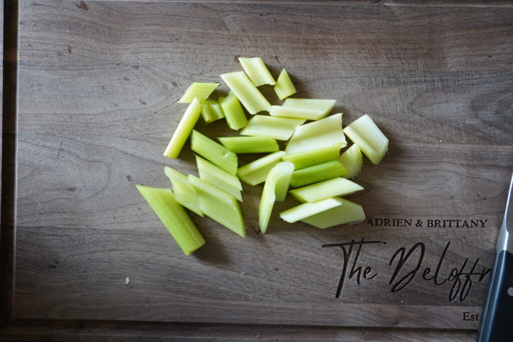 Chopped celery for the baked chicken recipe.