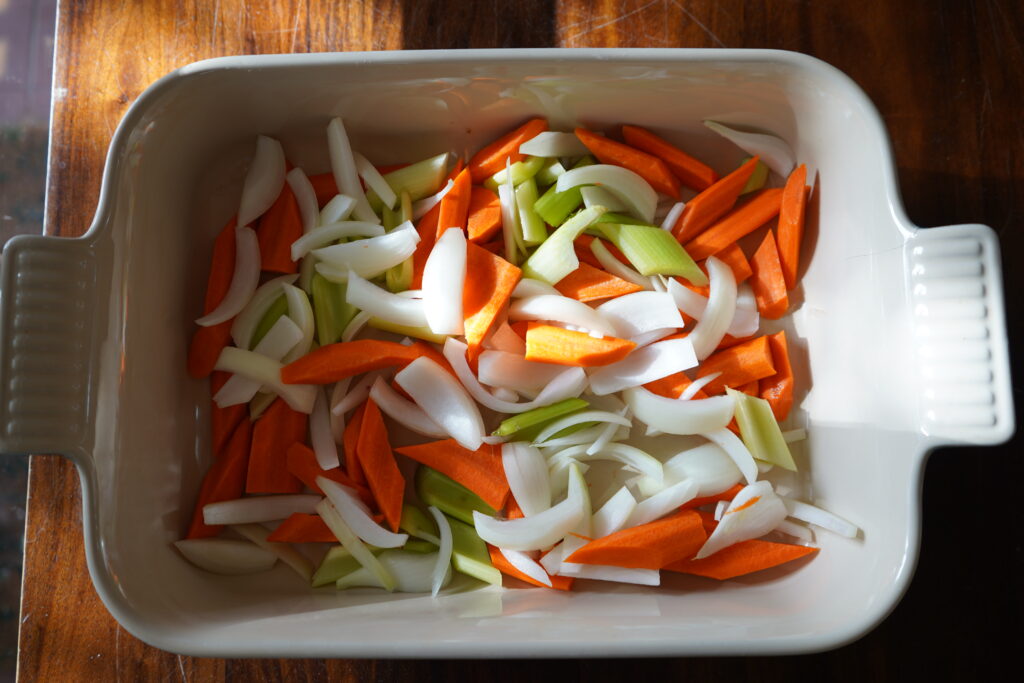 Chopped vegetables for the chicken to lay in and cook.