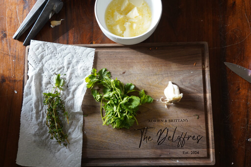 Preparing the herbs and garlic to put into the butter for garlic herb butter.