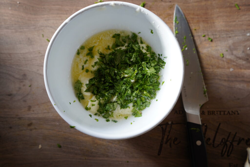 Chopped cilantro on top of the garlic herb butter.