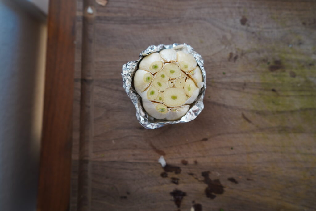 A whole garlic that has been wrapped in foil.