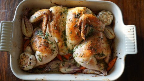 A whole chicken baked in butter herbs.