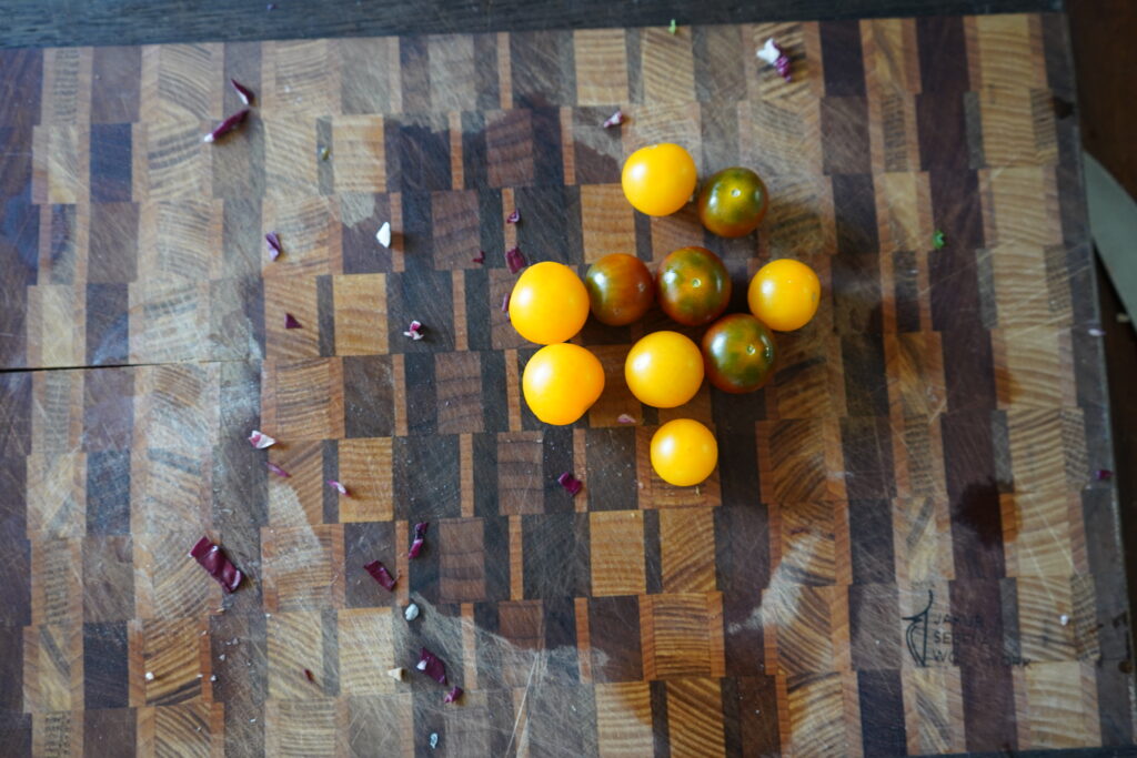 Colorful cherry tomatoes on a cutting board.