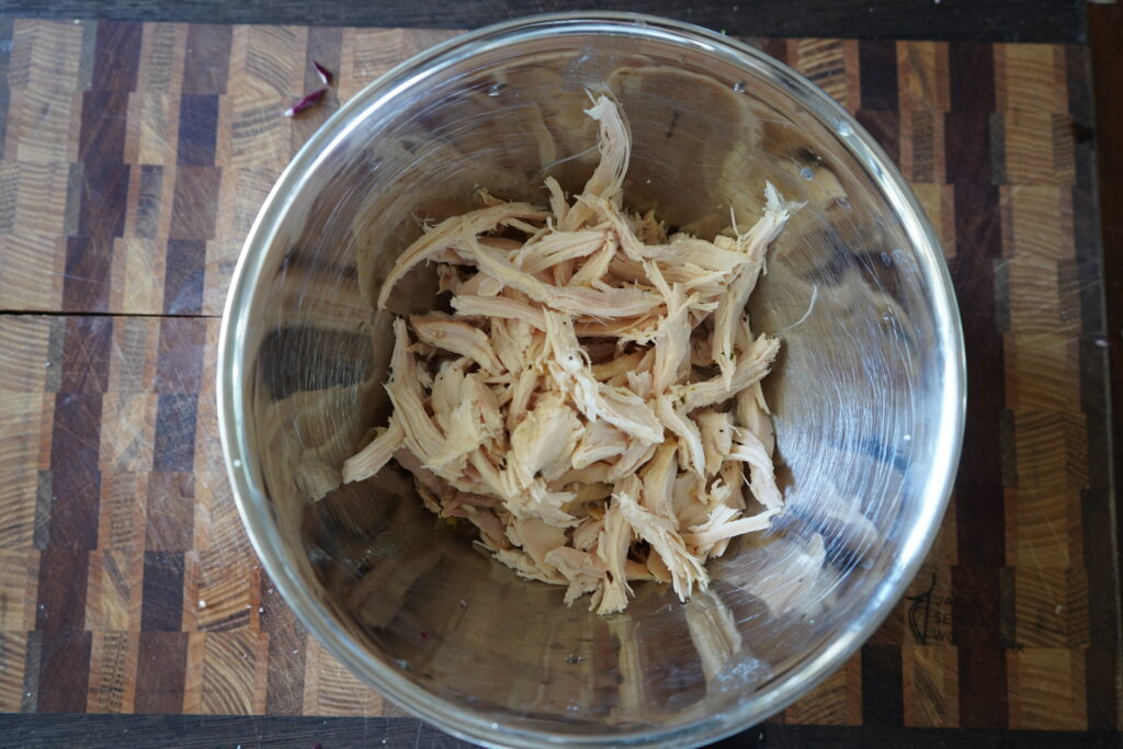 A bowl of shredded chicken.