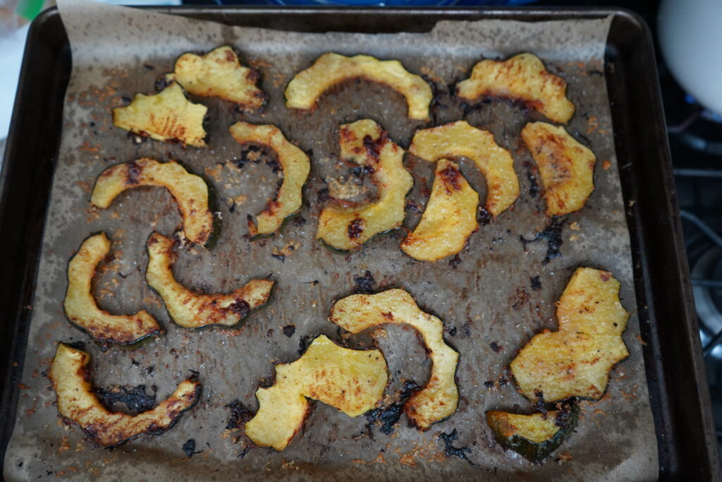 A baking sheet full of cooked acorn squash.