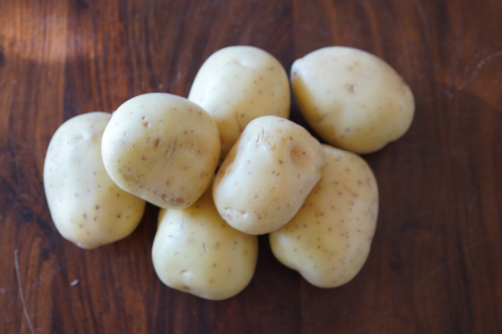 7 golden potatoes on a table