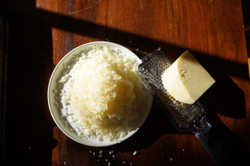 A plate of shredded cheese on a table