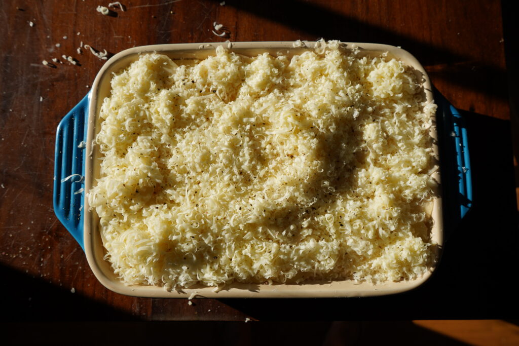 A baking dish full of potatoes and cheese