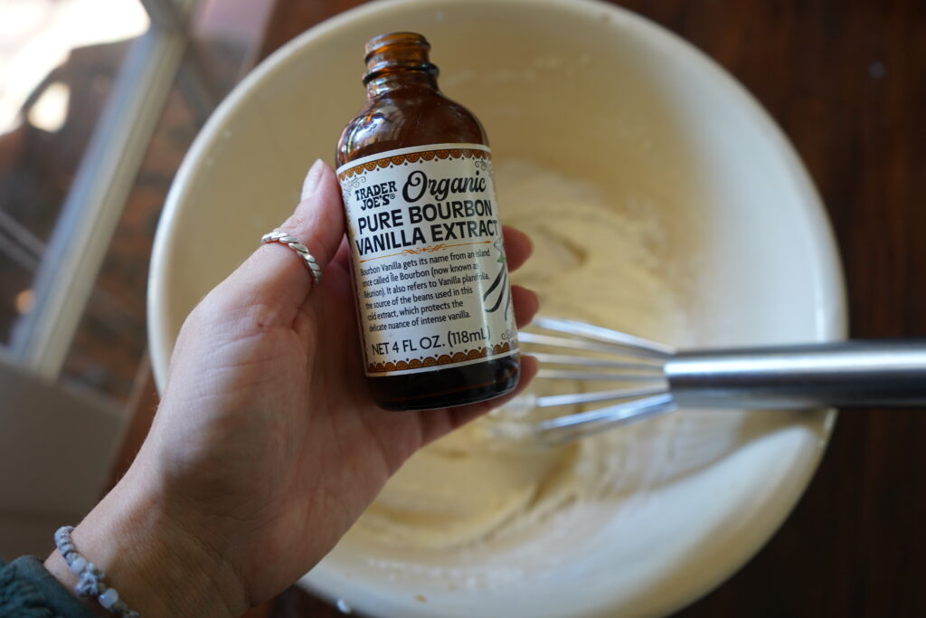 A hand holding vanilla extract