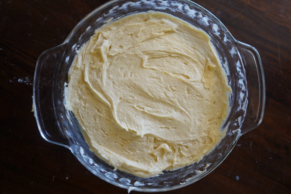 a pie dish with dough spread evenly inside