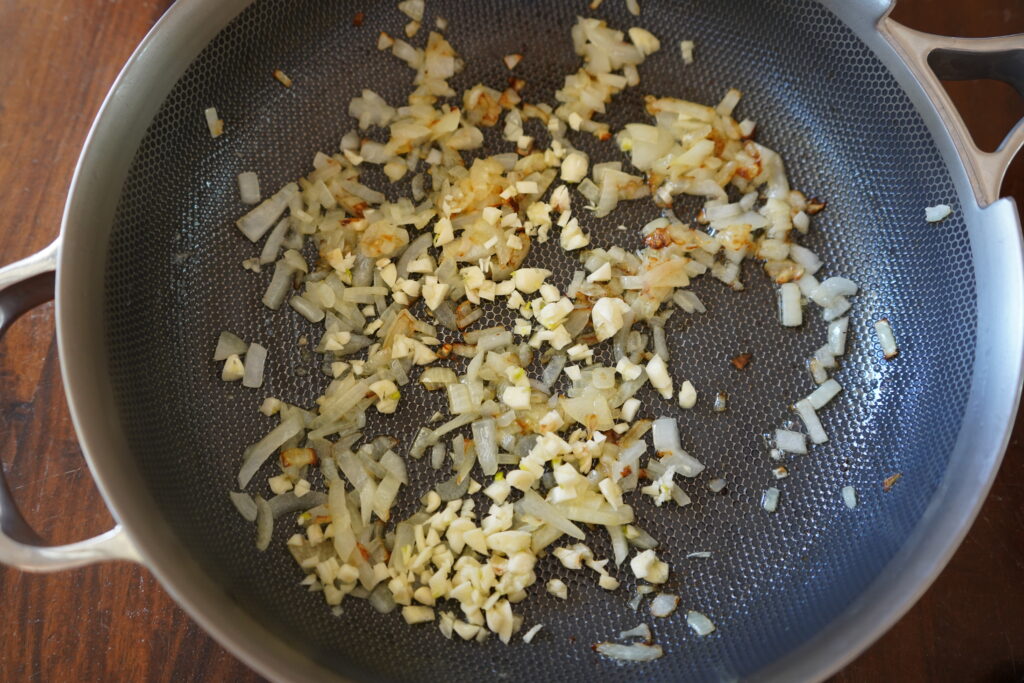 garlic that has been added to a pan of browning onions