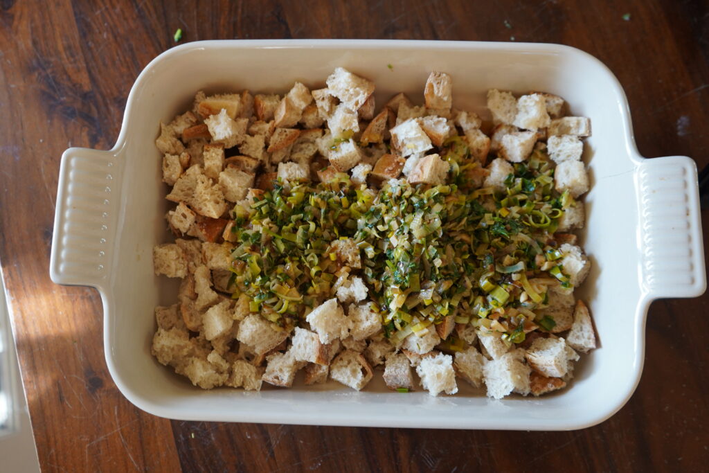 sauteed onions and leeks that have been poured over sourdough bread bits