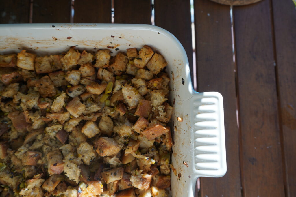 the corner of a baking casserole dish filled with stuffing