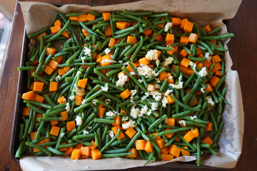 a layer of minced garlic on top of beans and butternut squash