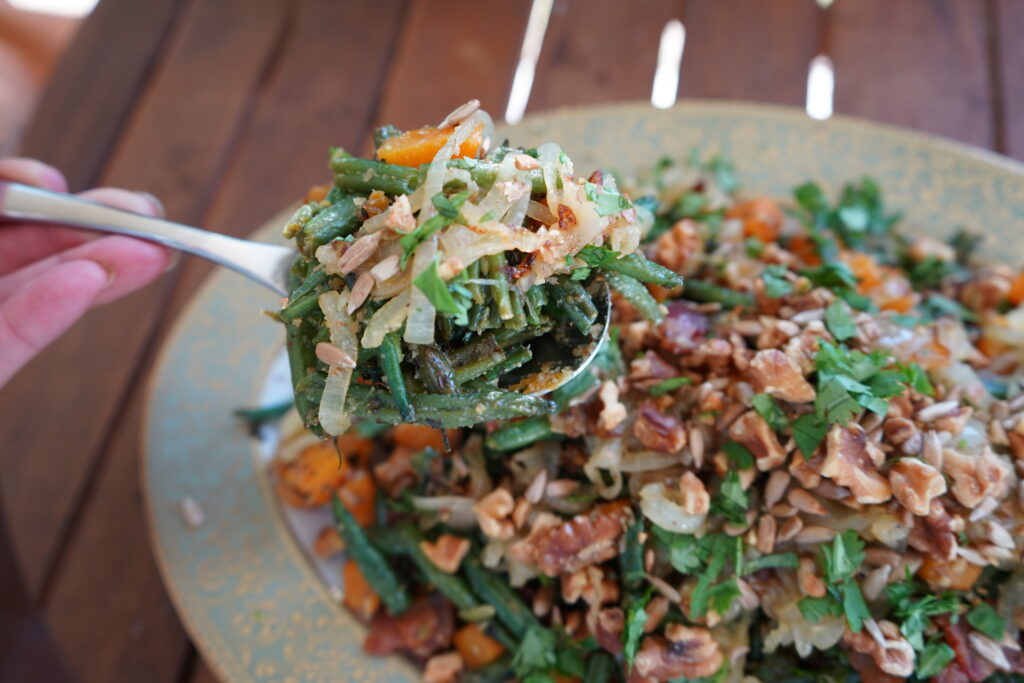 a spoon scooping up healthy green bean casserole 