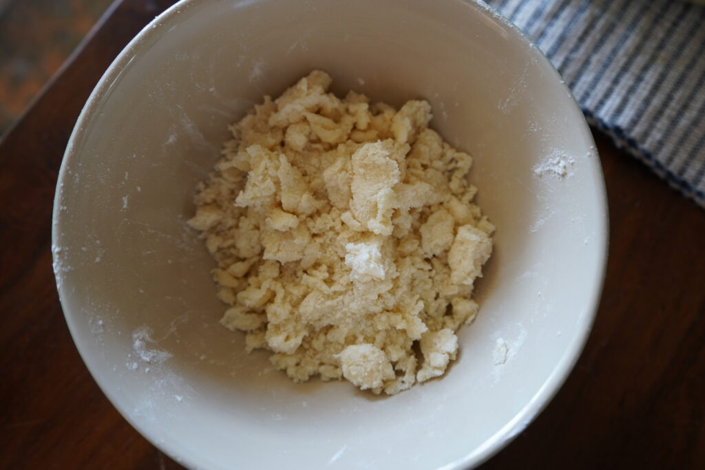 a bowl of mixed flour, sugar and butter