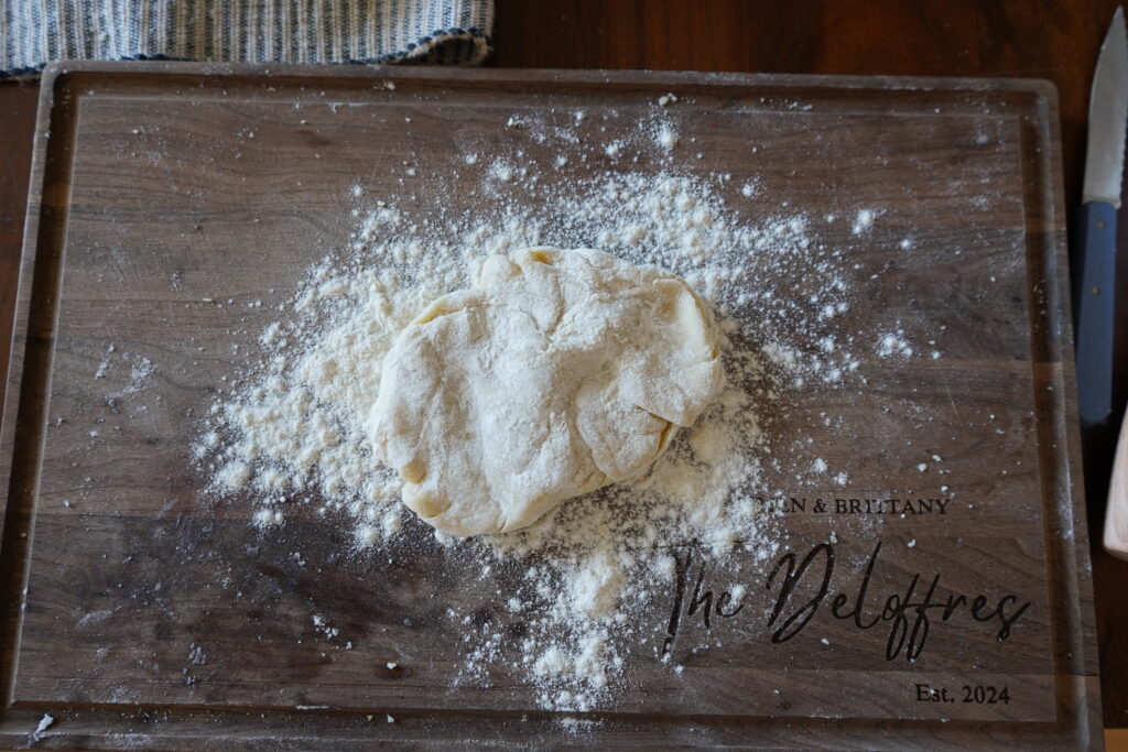 pie crust with flour on top of a cutting board