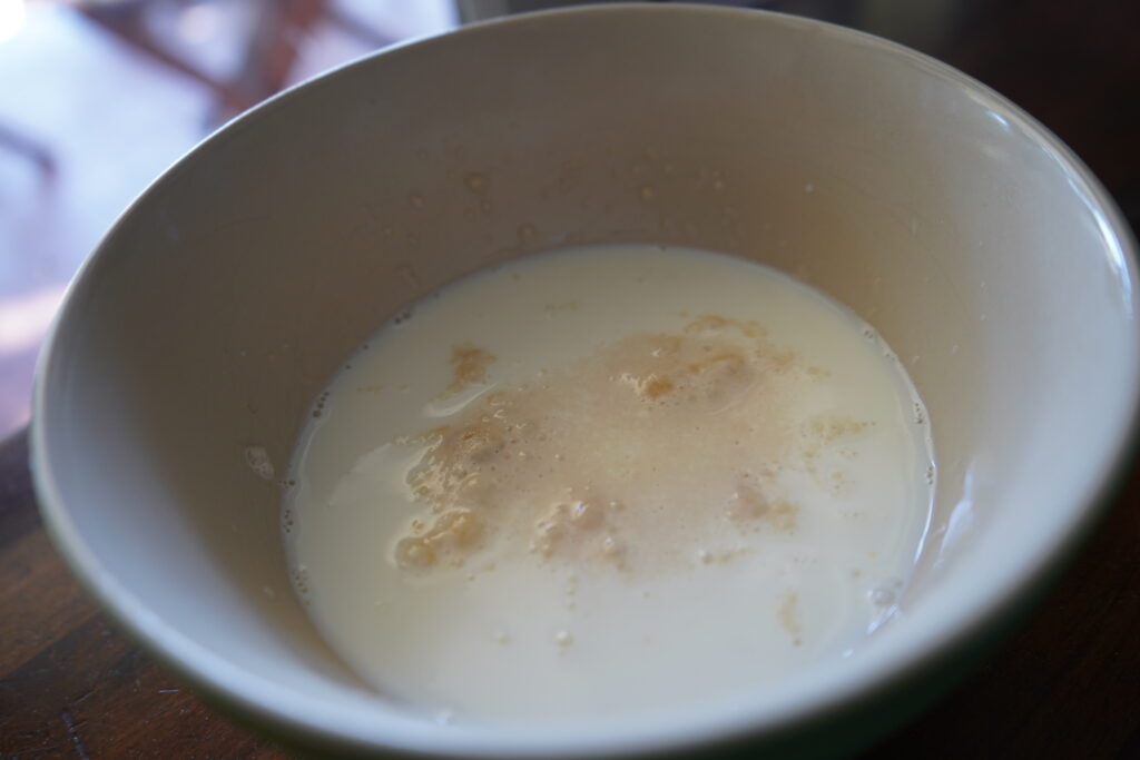 warm milk with yeast that is bubbling