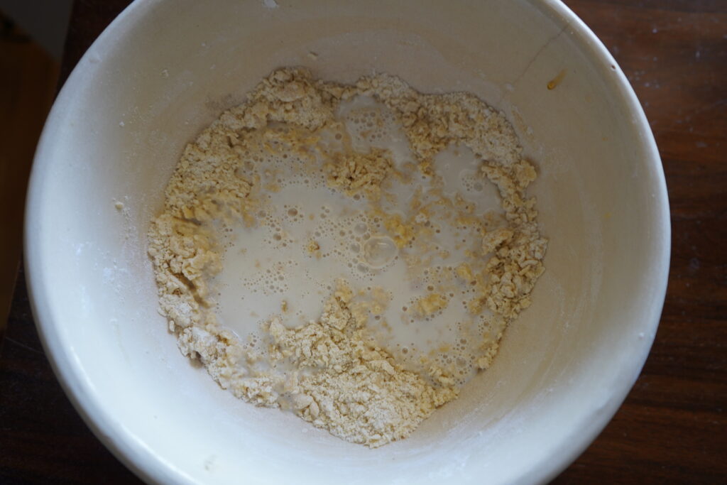 milk bubbling up in a bowl of flour