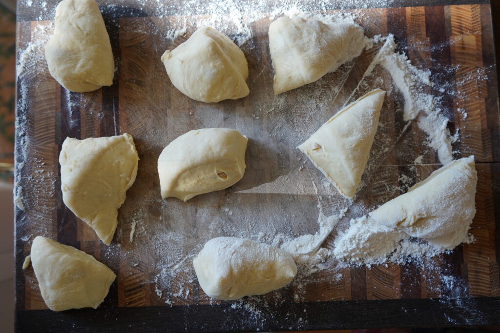 nine pieces of dough about to be rolled