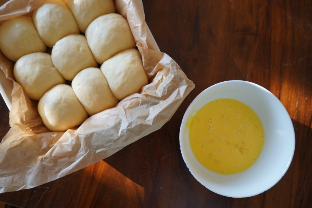 a bowl of egg wash next time a baking dish of uncooked buns