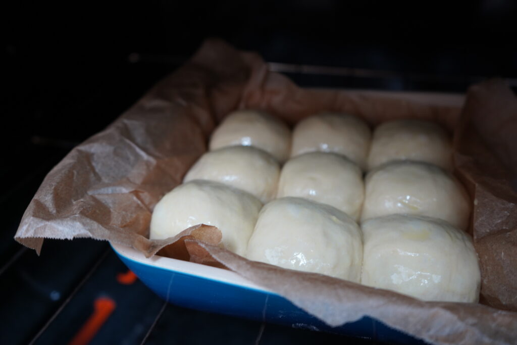 bread buns going into the oven