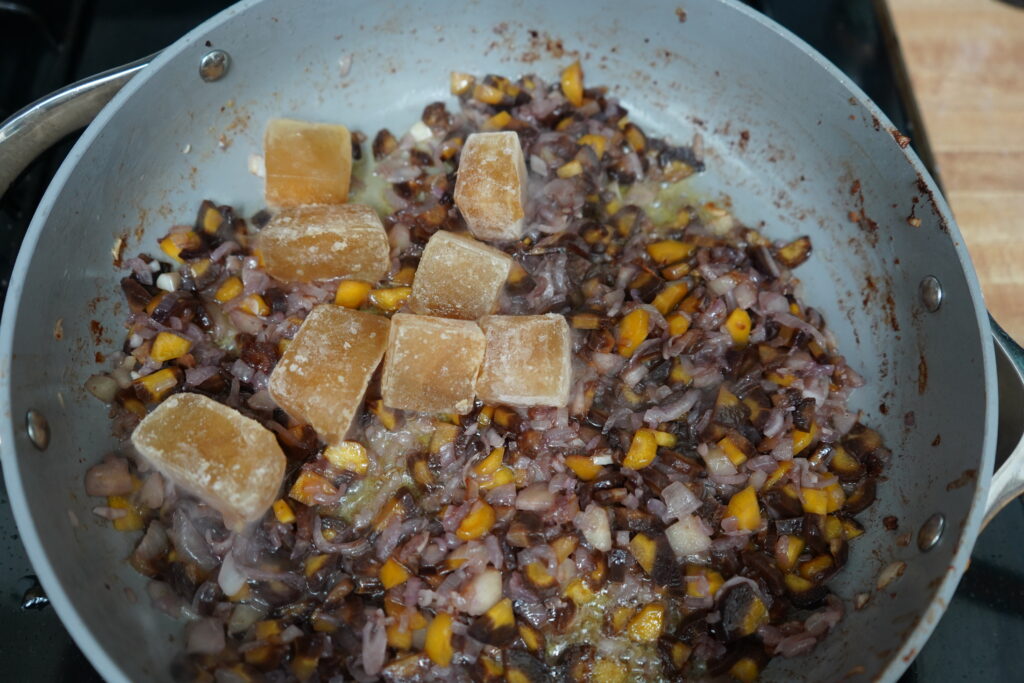 cubes of broth in a pan with vegetables