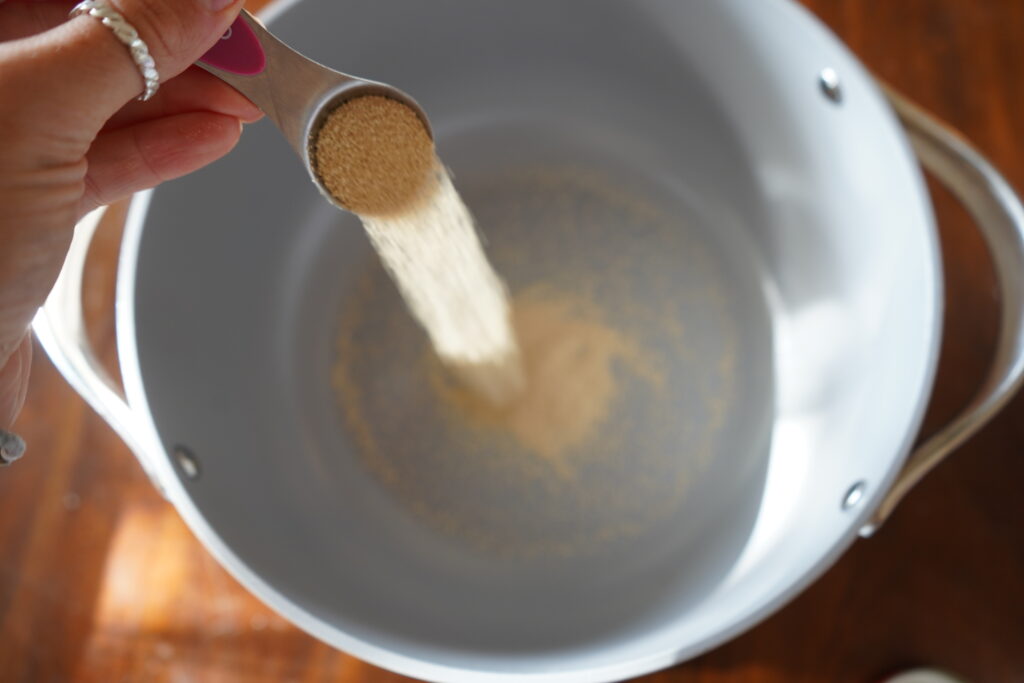 active yeast being poured into a bowl to prepare to make brioche