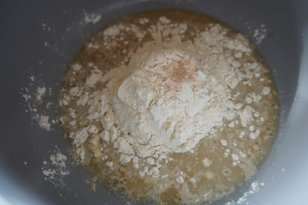 flour added to a bowl of yeast, water and honey