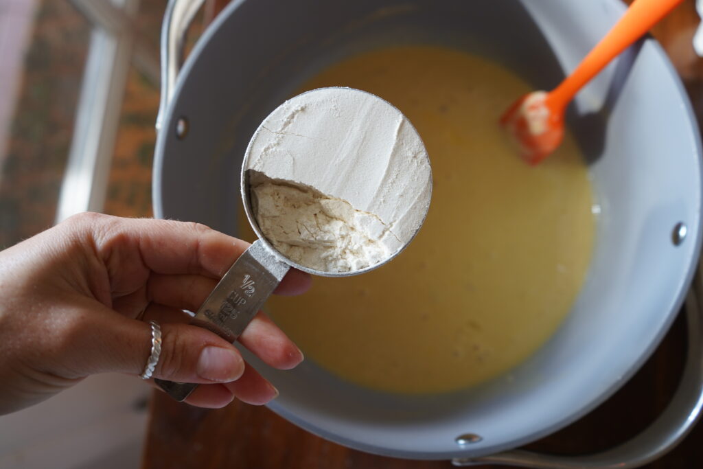 1/2 cup of flour over a mixing bowl of dough