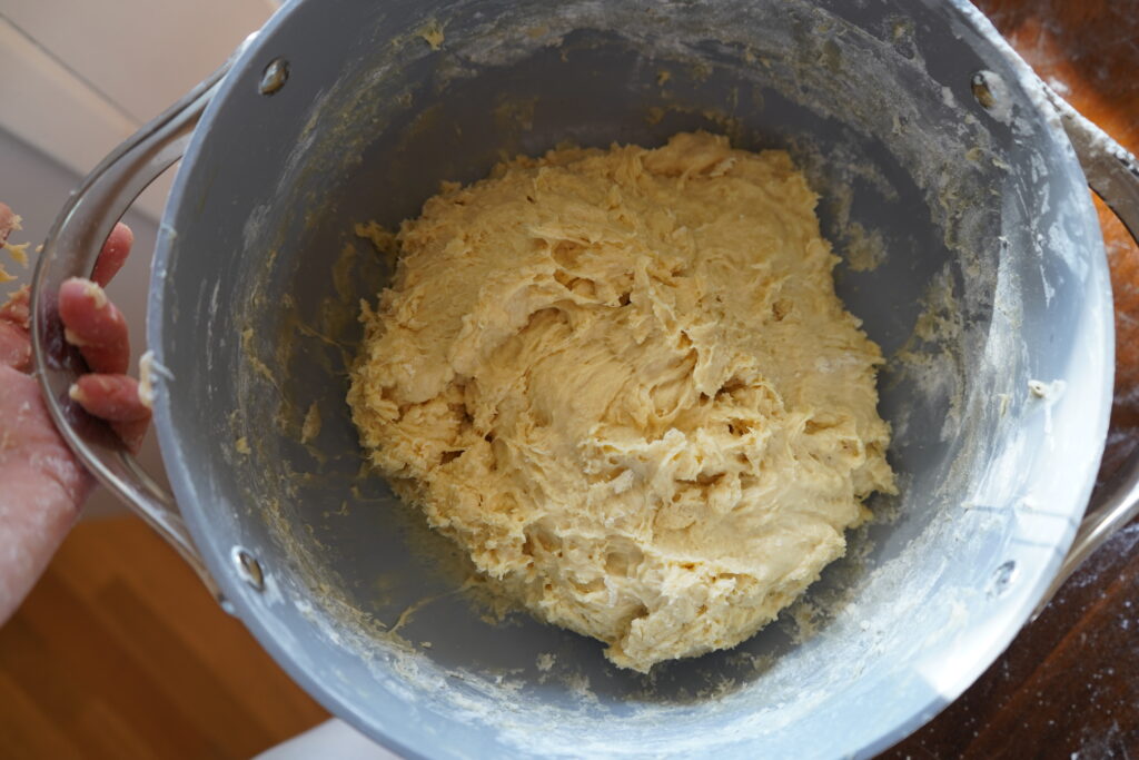 a sticky ball of dough in a mixing bowl