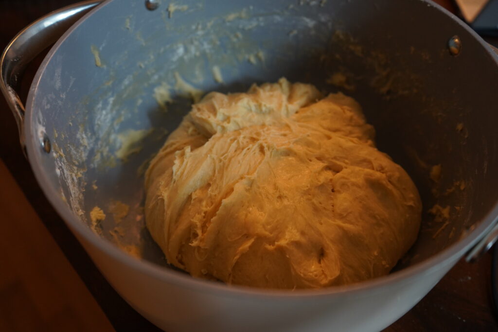 a big sticky dough ball  in a mixing bowl