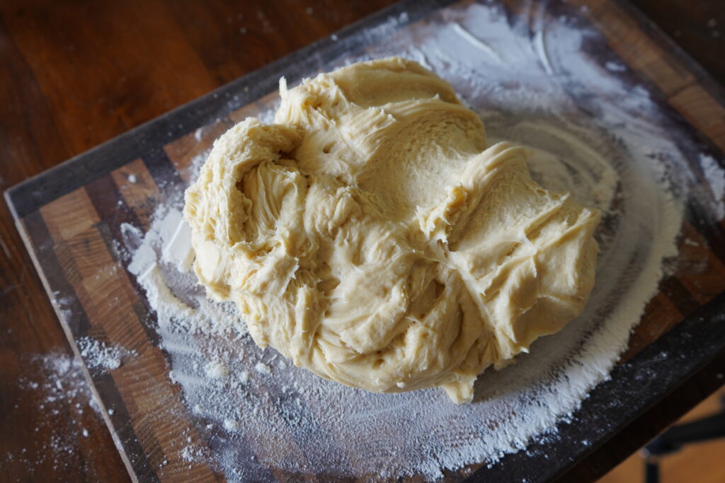 a bit lump of dough on a cutting board