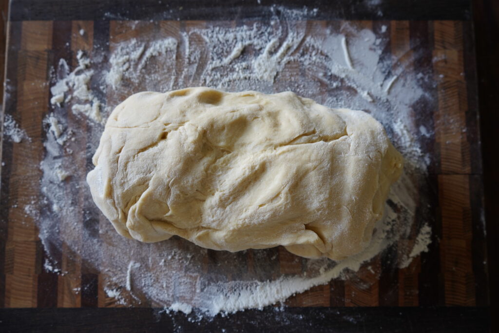 an oval shaped dough on a cutting board