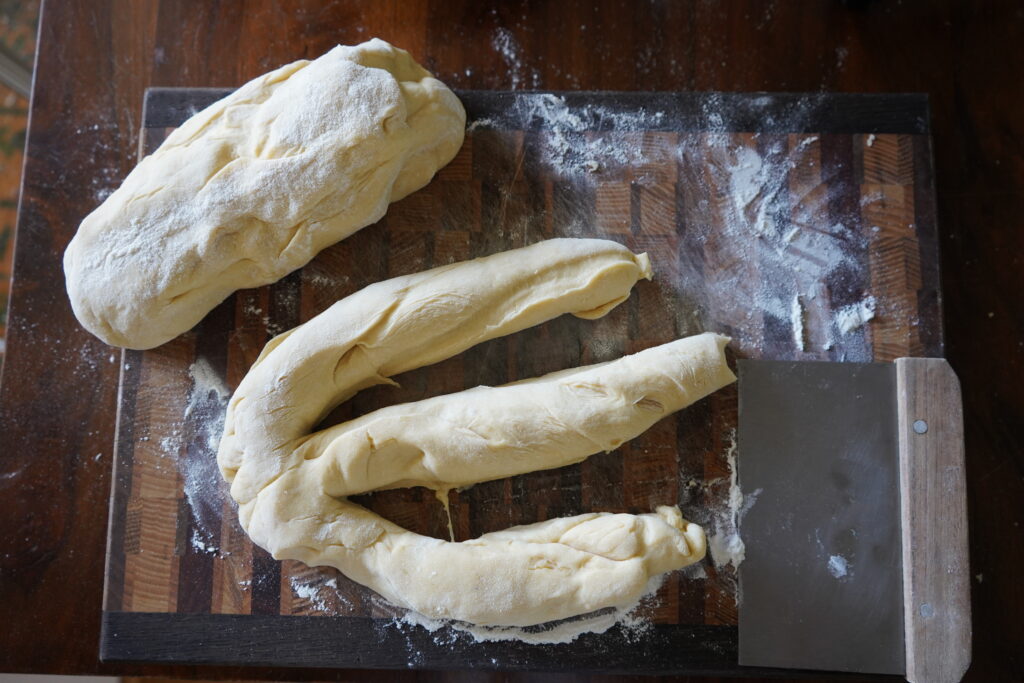 dough on a cutting board and cut into 3 long pieces