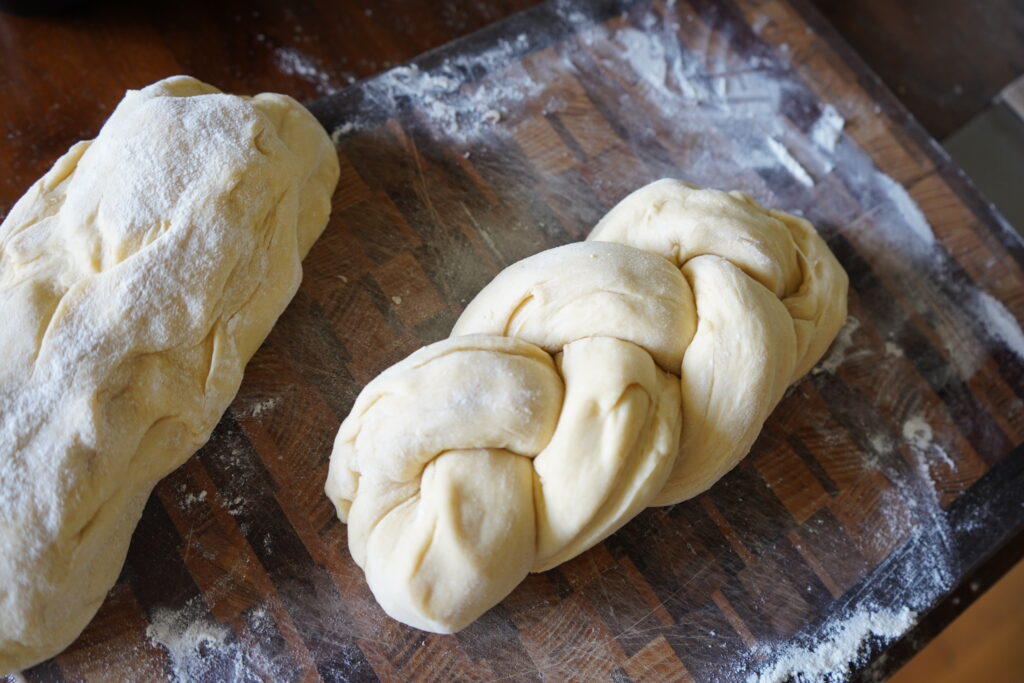 brioche dough braided on a cutting board