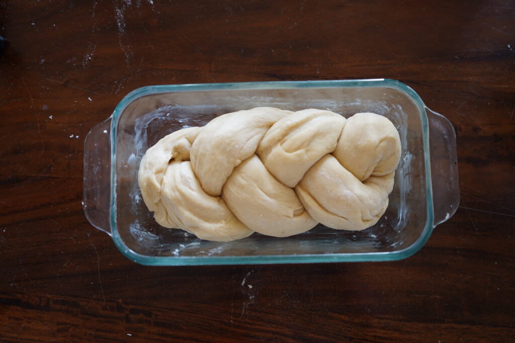 breaded brioche inside a buttered bread pan