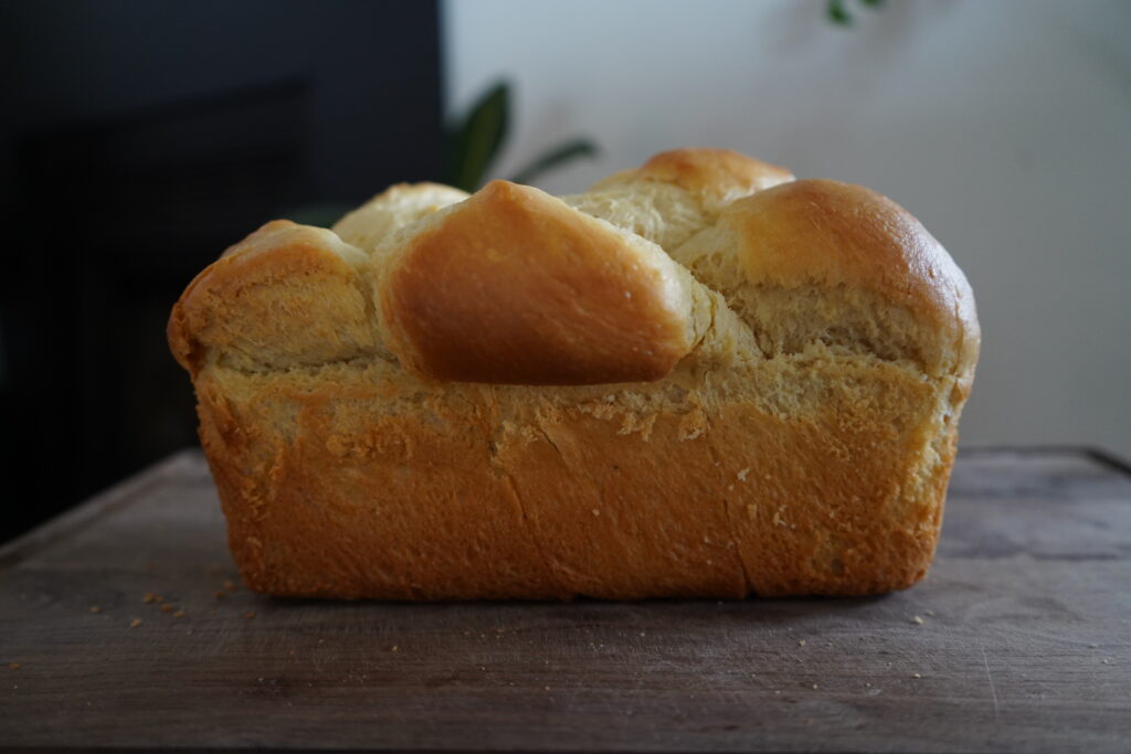 a big loaf of homemade brioche on a cutting board