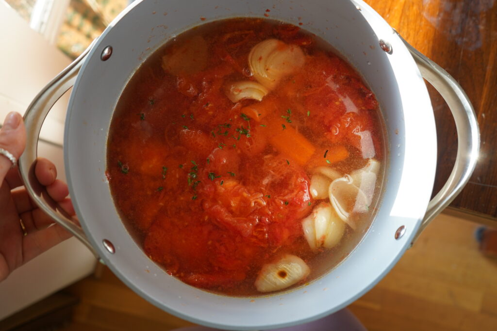 a pot of vegetables in broth