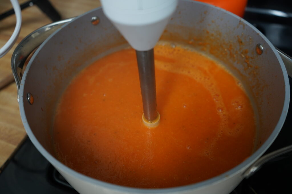 immersion blender in a pot making soup