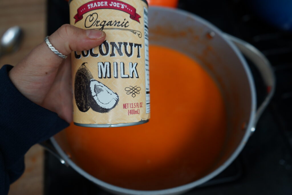 a can of organic coconut milk over a pot of soup