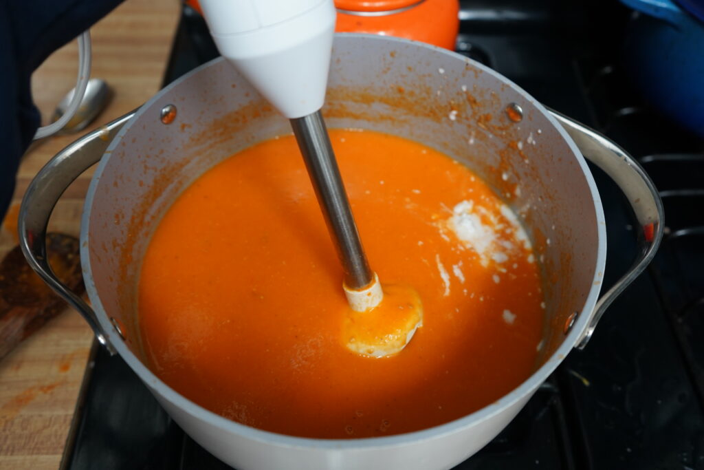 soup made with tomatoes being blended 