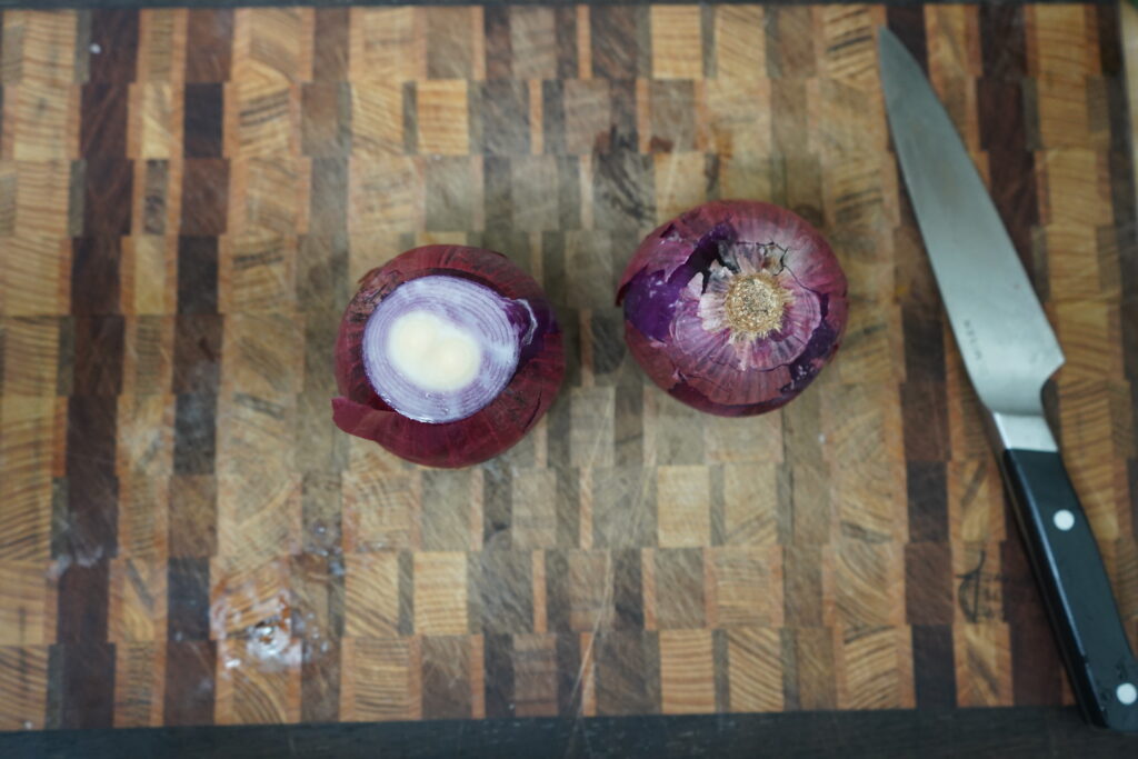 two red onions on a cutting board