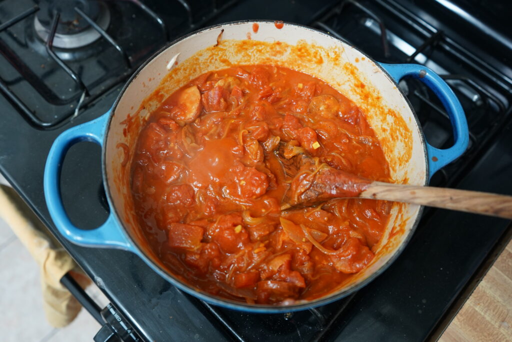 a Dutch oven of food simmering on the oven