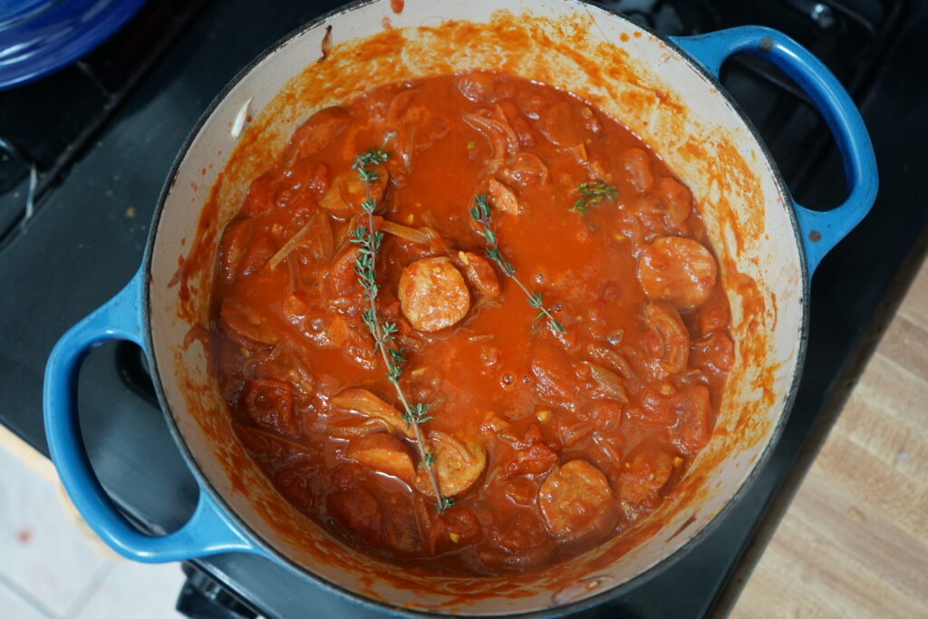 thyme being added to the rougail dish